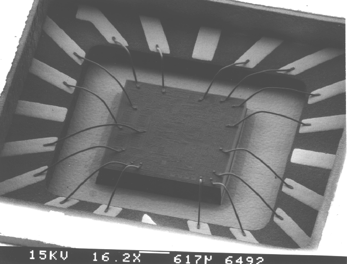 Shows a view of the cavity of a device successfully delidded without damage to wirebond loops. Photo courtesy of Analytical Solutions, Inc.