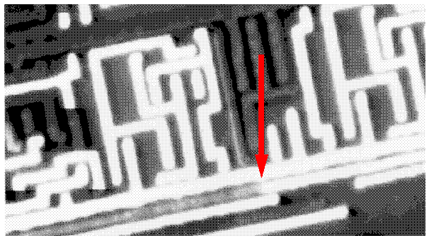 Voltage contrast image showing voltage change at a step over oxide due to partially open interconnect. (Courtesy Sandia Labs).