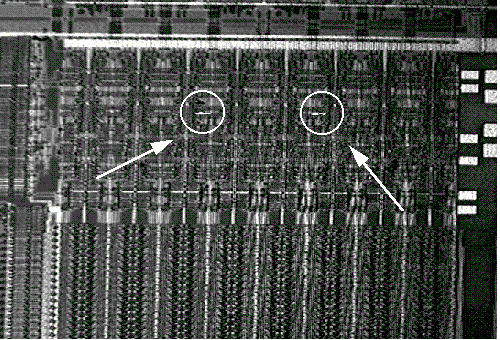 Combined LIVA and reflected light image showing the signal in Fig. 1 at higher magnification. (Courtesy Sandia Labs).
