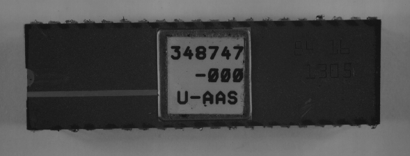 Low power optical photograph showing an example of markings on an IC. (Photo courtesy Sandia Labs).